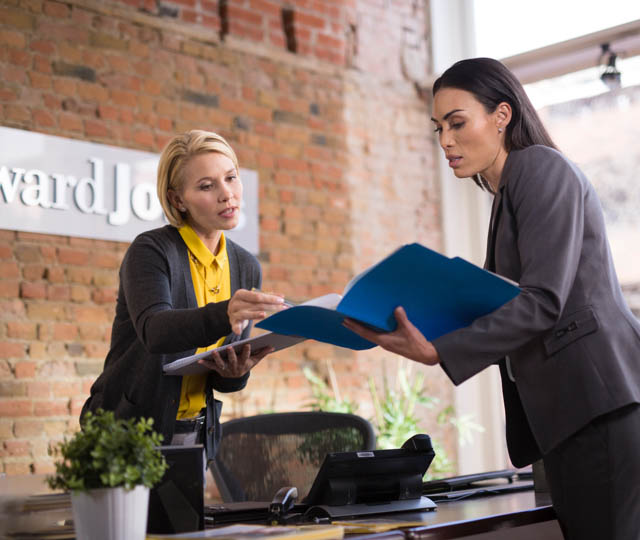 Two women reviewing documentation