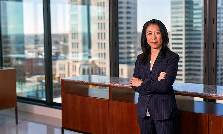 Business woman stands proudly with crossed arms