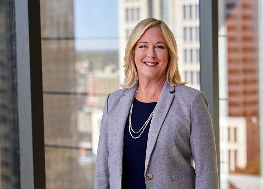 business woman standing confidently in metro office setting