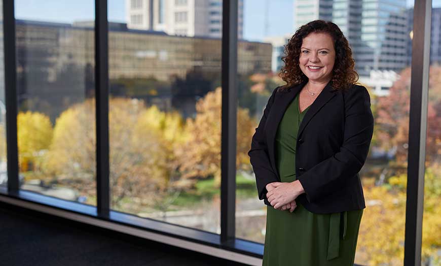 Financial Advisor Helen Rice smiling by an office window